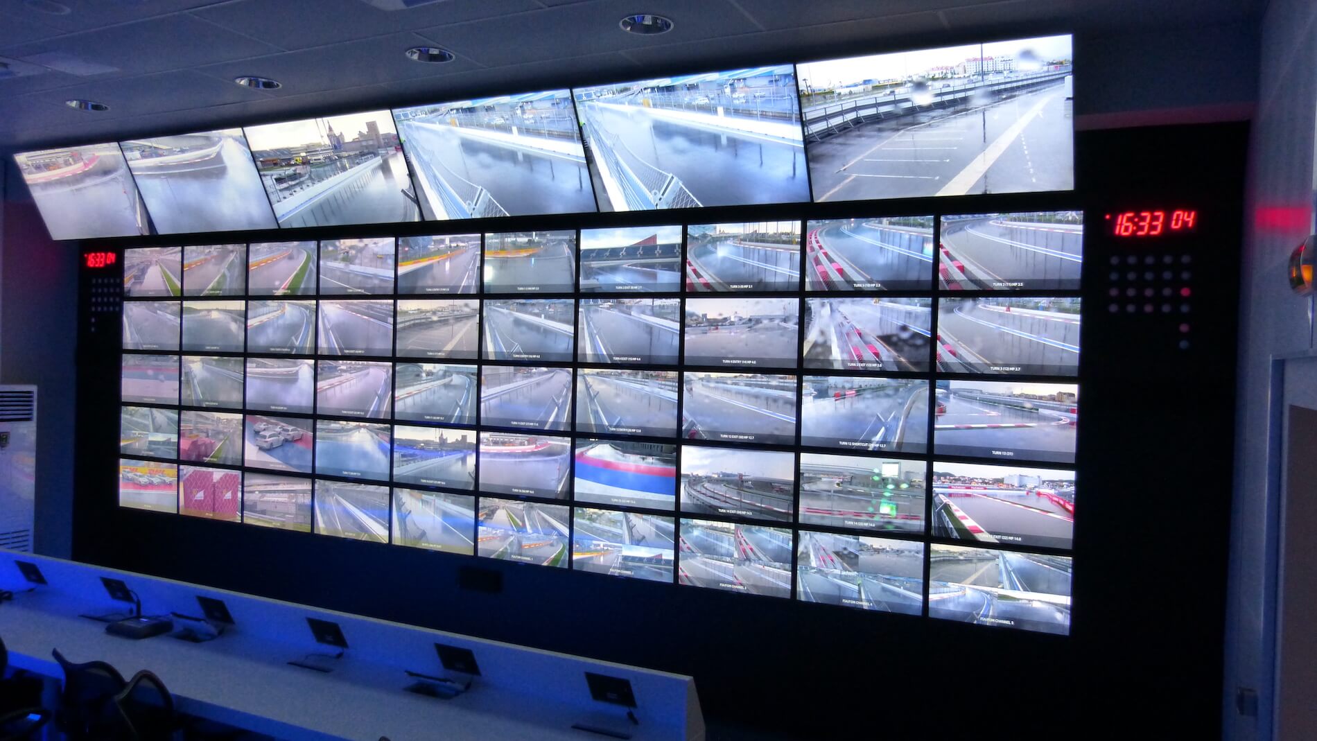 A wall with a lot of TV screens on it