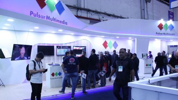A group of people at the Pulsar Multimedia booth